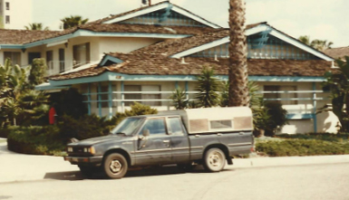 Archive photo of an older painted house and work truck from the family's painting history in the late 1970s or 1980s