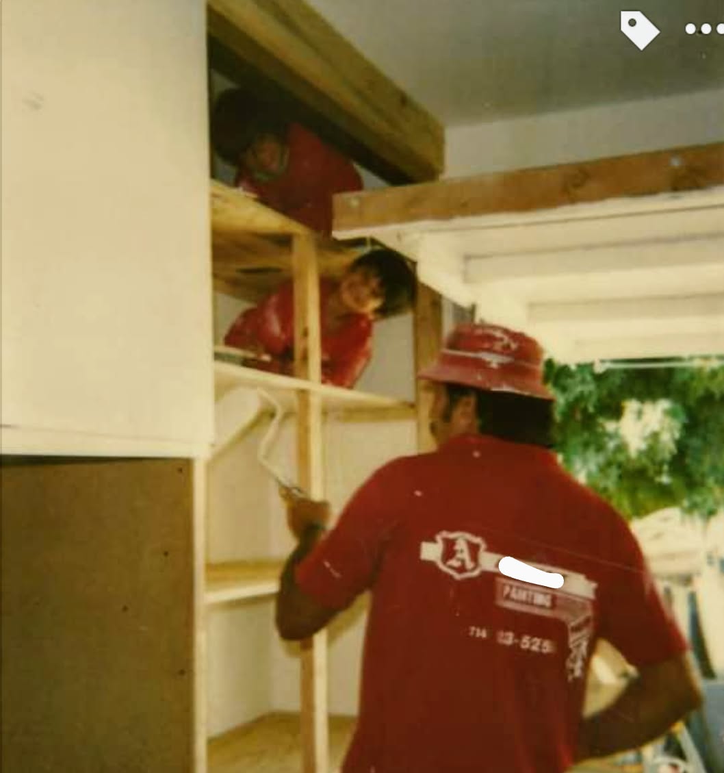 Archive photo of Jed Roper painting on a job site in the early 1990s